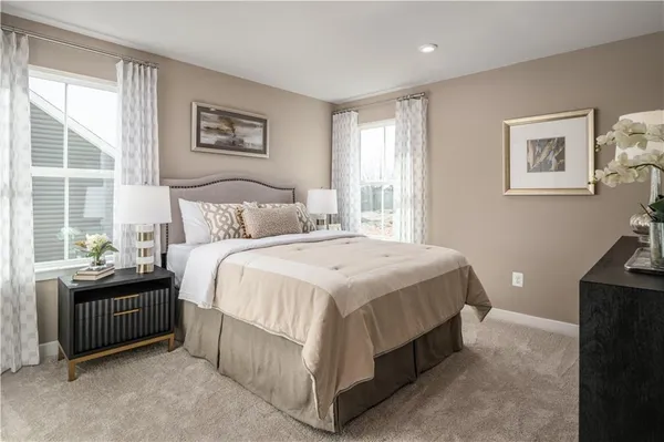 a spacious bedroom with a bed and a desk