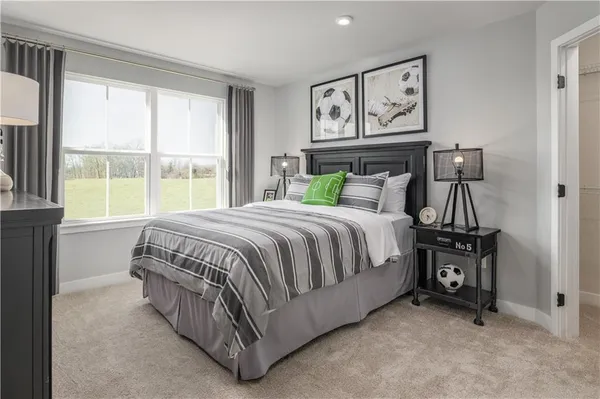 a bedroom with a bed and large window