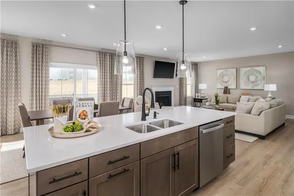 a kitchen with stainless steel appliances a sink a stove and a chandelier