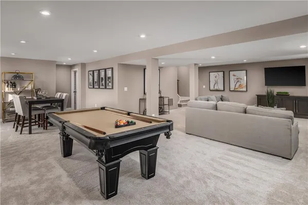 a living room with furniture a flat screen tv and a table