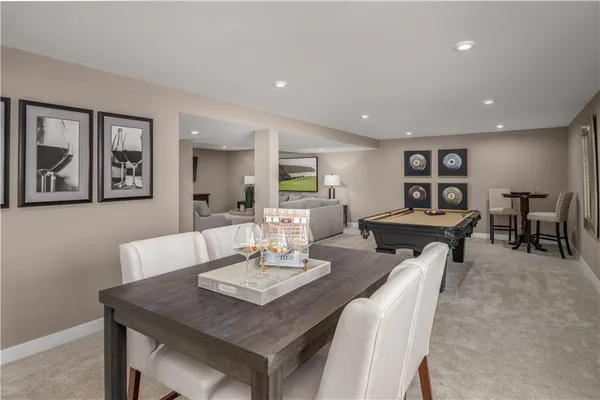 a living room with furniture a table and kitchen view