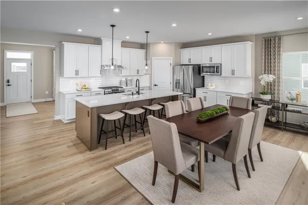 a large kitchen with a table and chairs