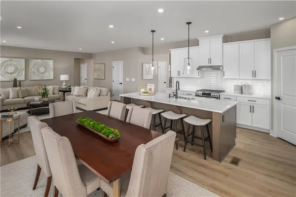 a large kitchen with a table and chairs