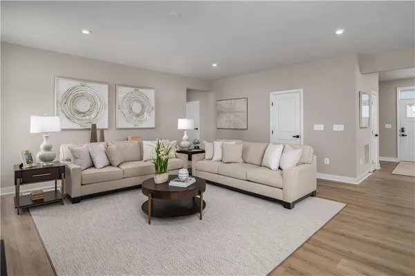a living room with furniture and a wooden floor