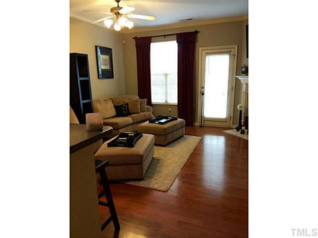 7610 Winners Edge Street Raleigh, NC 27617 - Photo 3 of 17 a living room with furniture and a chandelier