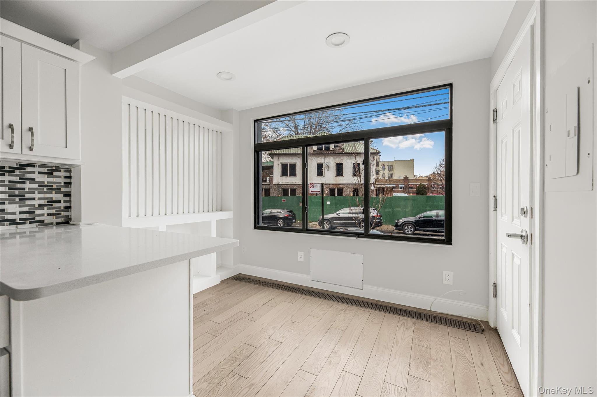 3067 Williamsbridge Road Bronx, NY 10467 - Photo 18 of 29 a view of an empty room with a window and wooden floor