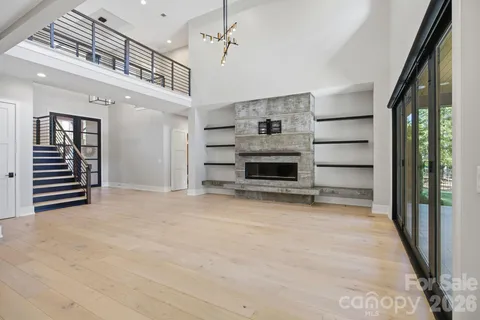 a view of a hallway with stairs and a living room