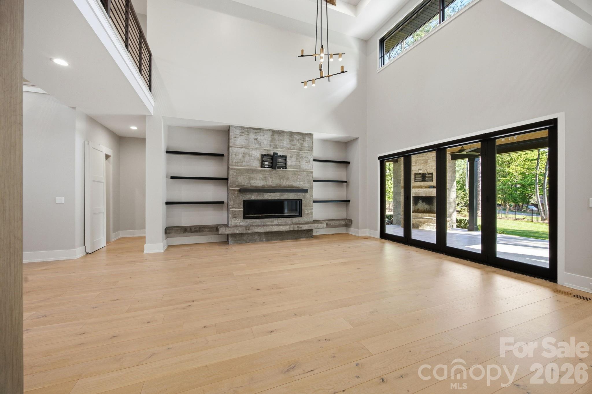 132 Binns Road Mooresville, NC 28117 - Photo 14 of 48 a view of empty room with a fireplace and windows