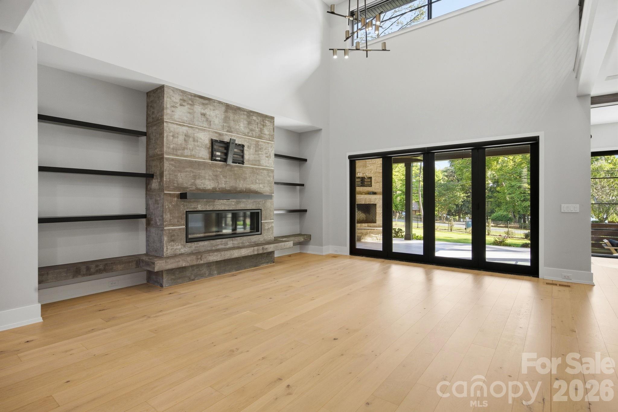 132 Binns Road Mooresville, NC 28117 - Photo 15 of 48 a view of an empty room with a fireplace and a window