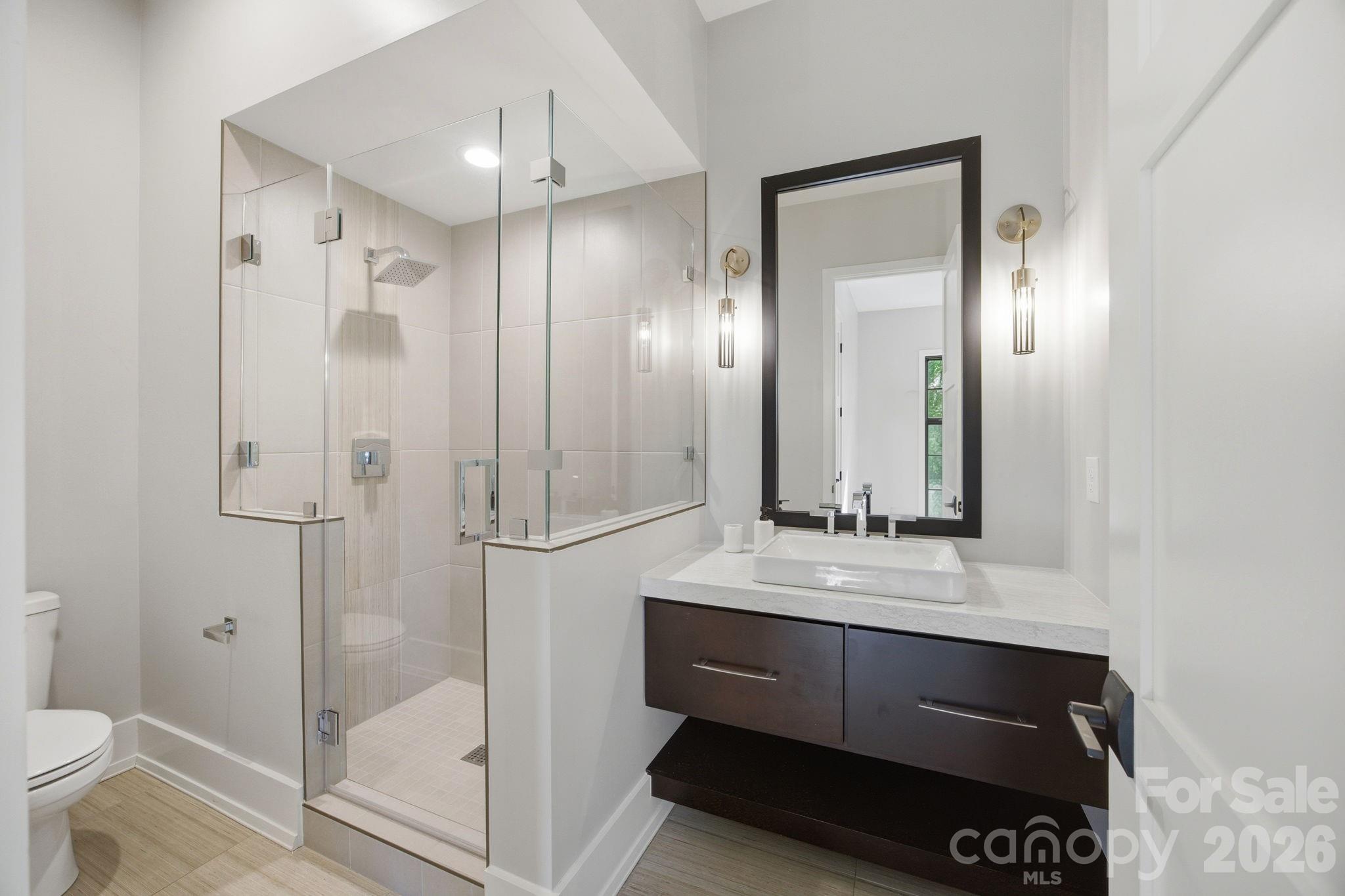 132 Binns Road Mooresville, NC 28117 - Photo 18 of 48 a bathroom with a shower a sink and a mirror