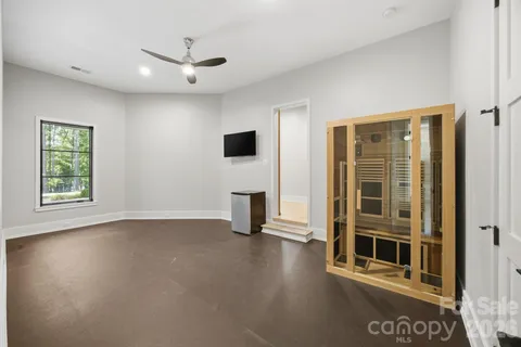 an empty room with windows fireplace and windows