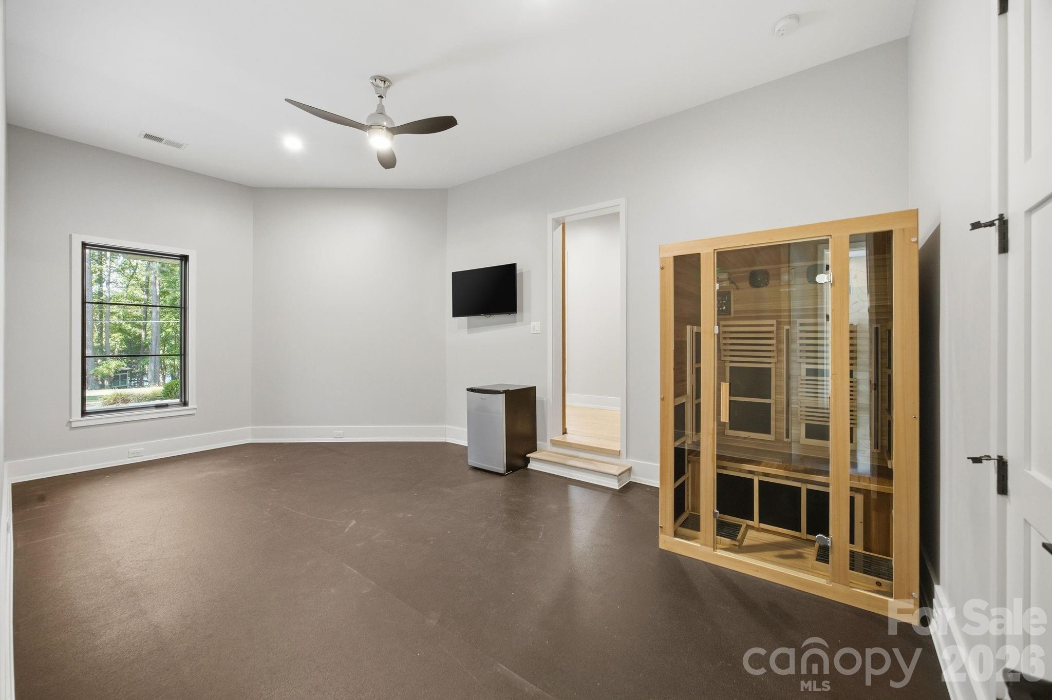132 Binns Road Mooresville, NC 28117 - Photo 19 of 48 an empty room with windows fireplace and windows