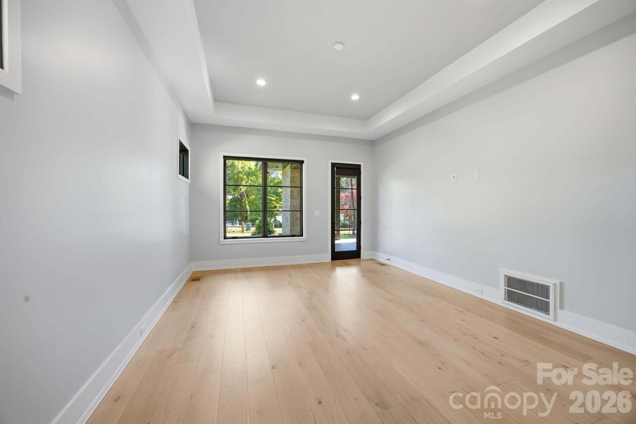 132 Binns Road Mooresville, NC 28117 - Photo 24 of 48 an empty room with wooden floor and windows
