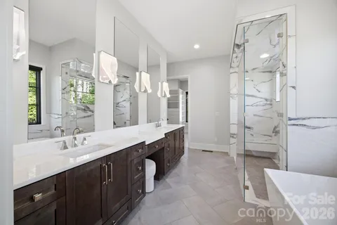 a spacious bathroom with a double vanity sink mirror double and shower