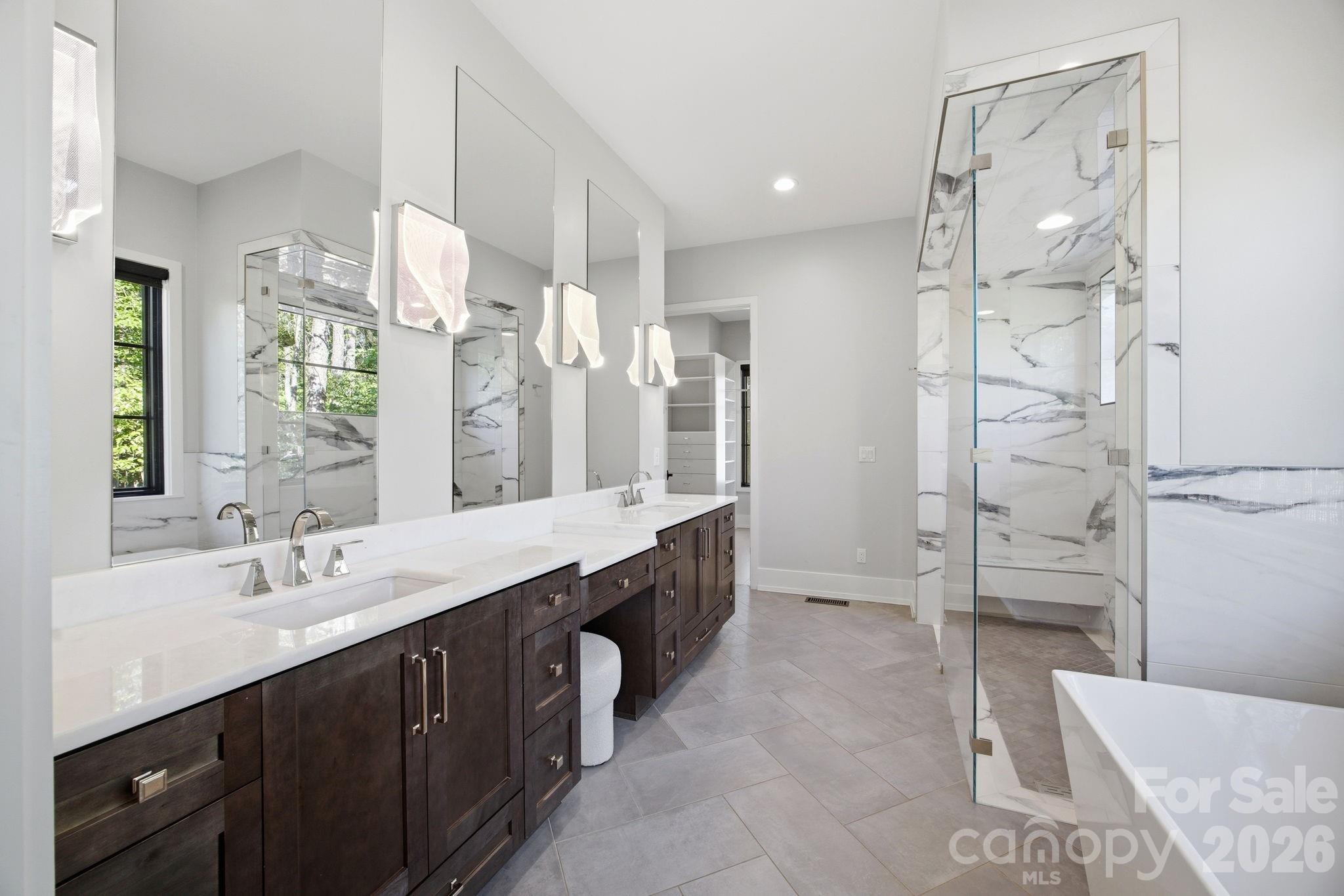 132 Binns Road Mooresville, NC 28117 - Photo 25 of 48 a spacious bathroom with a double vanity sink mirror double and shower