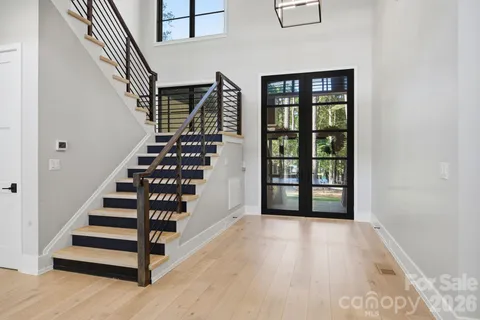 a view of entryway with wooden floor and front door