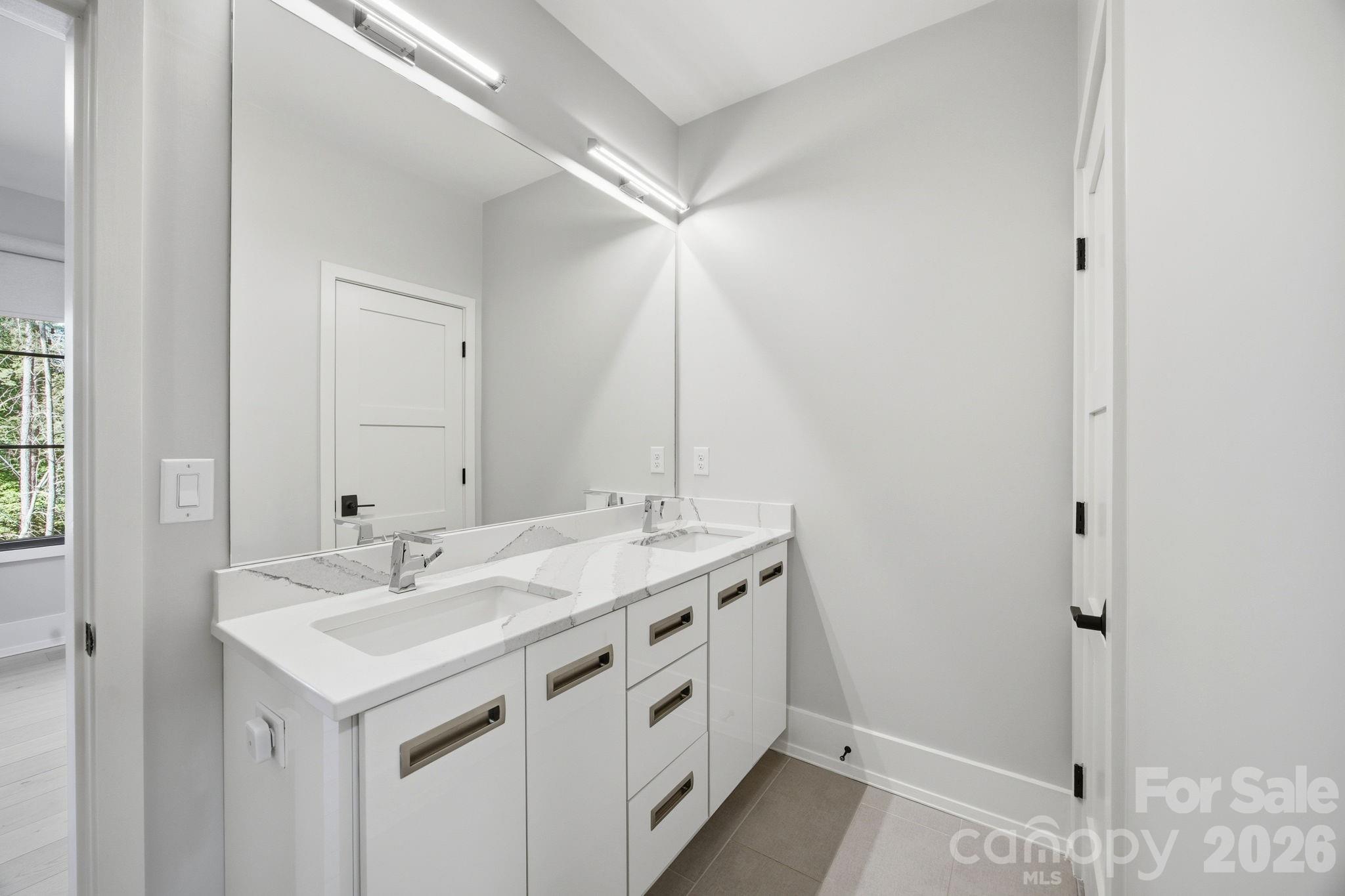 132 Binns Road Mooresville, NC 28117 - Photo 33 of 48 a spacious bathroom with a sink and a mirror
