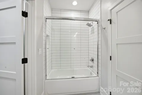 a bathroom with a shower and a tub