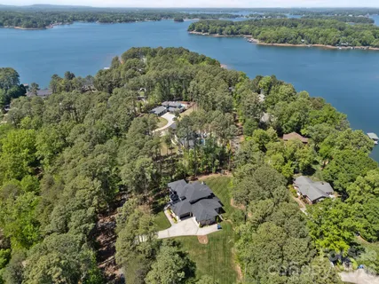 an aerial view of a house with a lake view