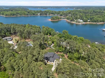 an aerial view of a houses with a lake view