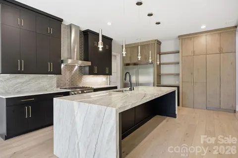 a kitchen with stainless steel appliances granite countertop a sink counter space and cabinets