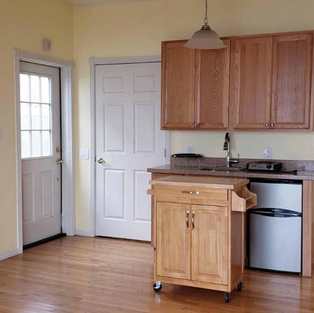 432 Heathcliff Drive Pacifica, CA 94044 - Photo 3 of 6 a kitchen with granite countertop wooden cabinets and white appliances