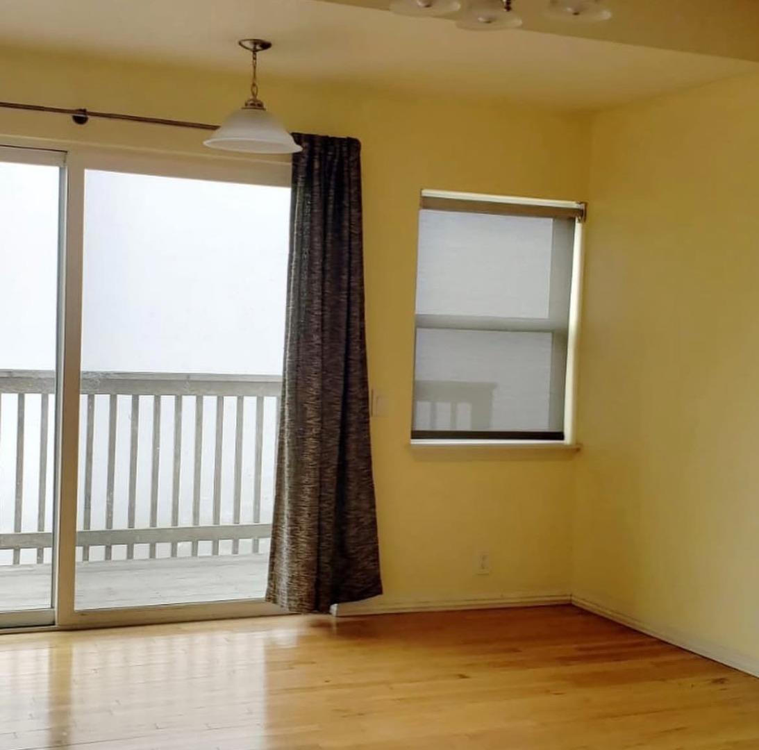 432 Heathcliff Drive Pacifica, CA 94044 - Photo 4 of 6 a view of an empty room with a window and wooden floor