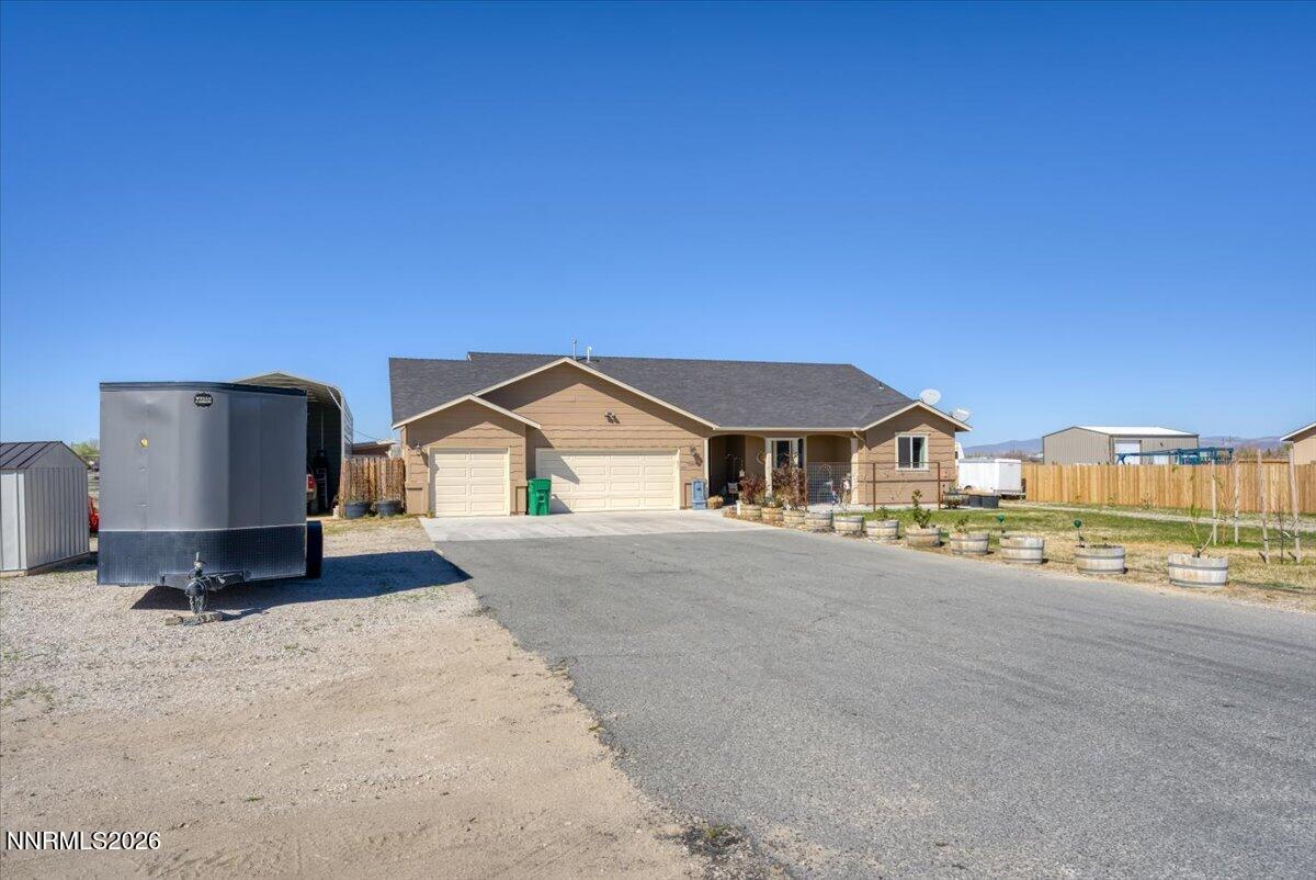 1197 Sky Ridge Drive Fallon, NV 89406 - Photo 62 of 79 a view of a house with a yard and garage