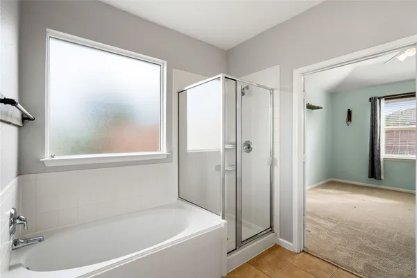 a bathroom with a bathtub and a shower