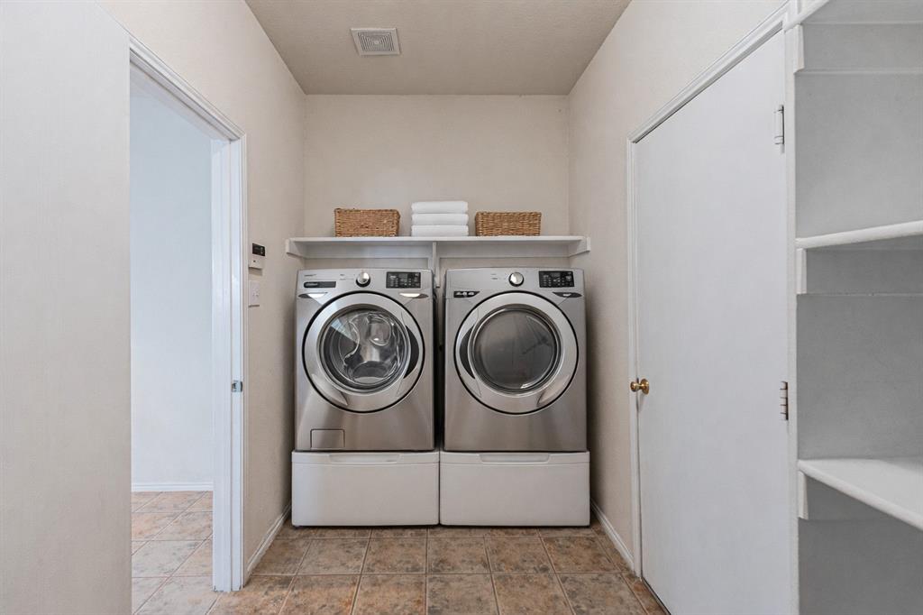 7804 Hidden Path Lane Denton, TX 76210 - Photo 15 of 40 a utility room with dryer and washer