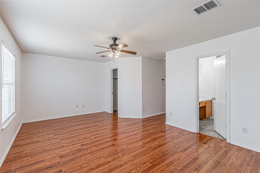 7804 Hidden Path Lane Denton, TX 76210 - Photo 20 of 40 wooden floor in an empty room with a window