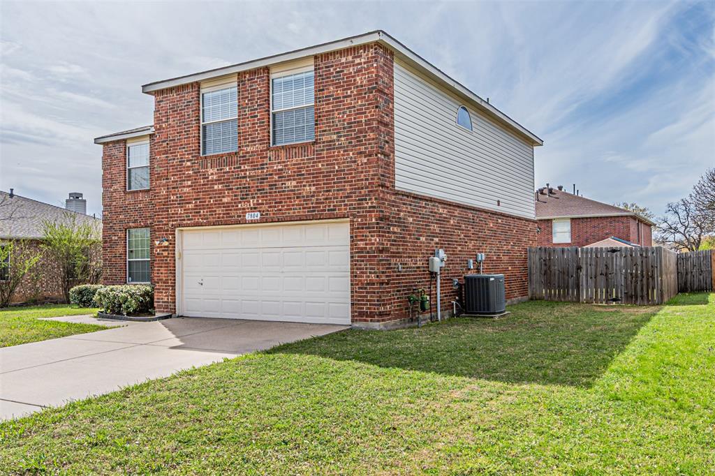 7804 Hidden Path Lane Denton, TX 76210 - Photo 2 of 40 a front view of a house with a yard and garage