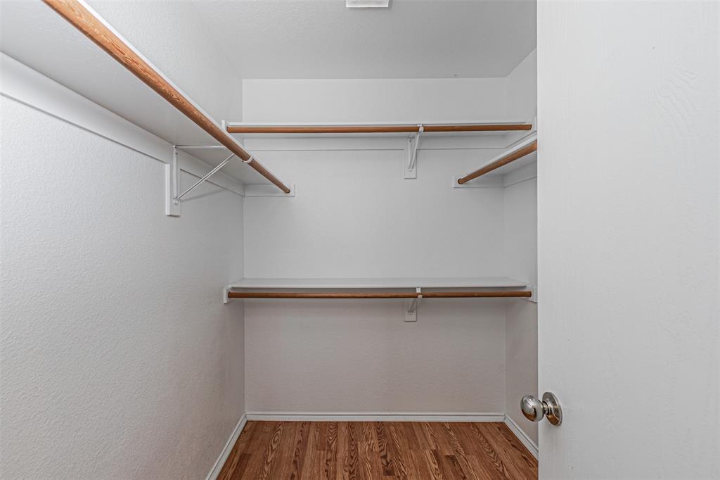 7804 Hidden Path Lane Denton, TX 76210 - Photo 21 of 40 a view of walk in closet with empty racks