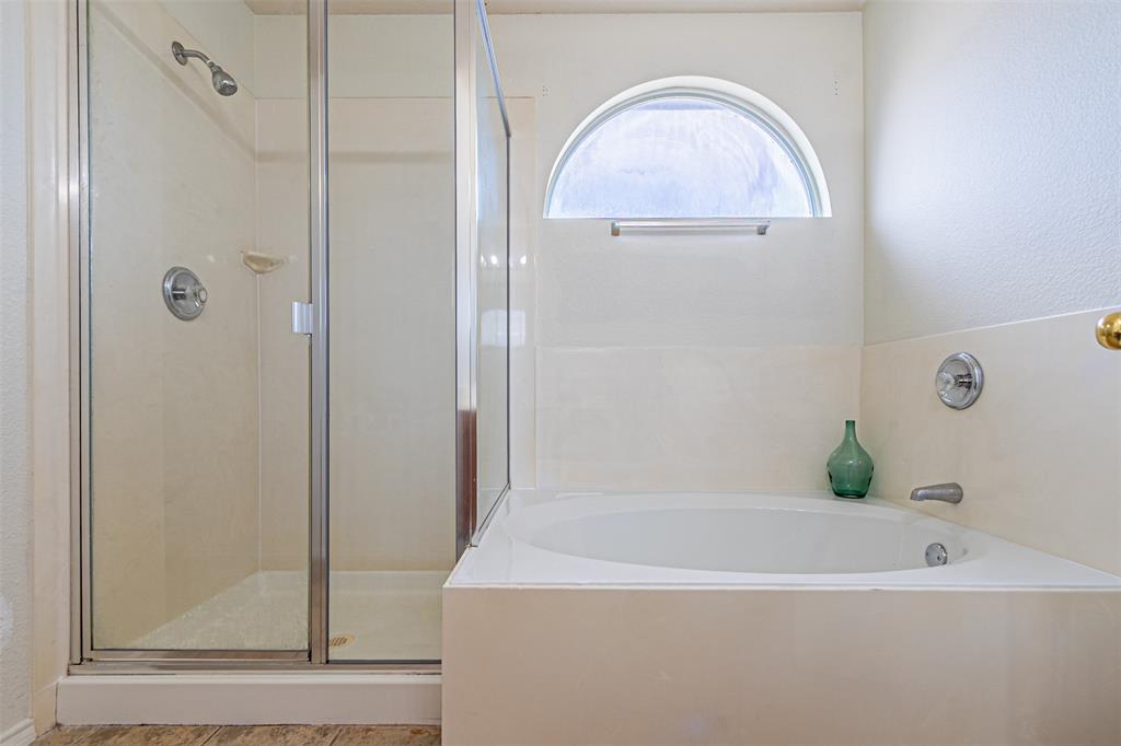 7804 Hidden Path Lane Denton, TX 76210 - Photo 23 of 40 a bathroom with a bathtub and a shower
