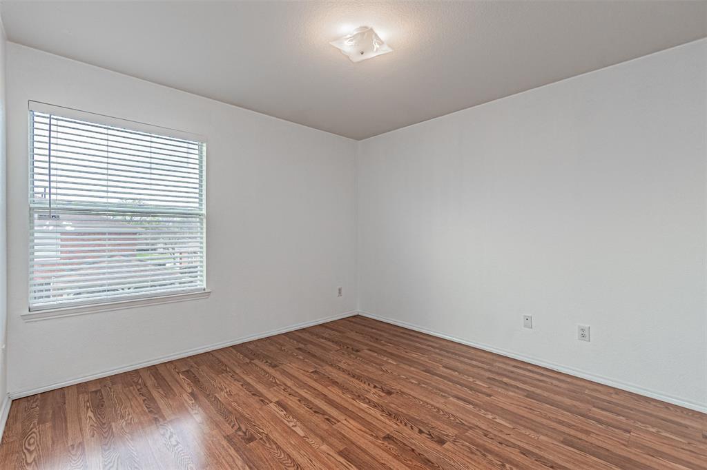 7804 Hidden Path Lane Denton, TX 76210 - Photo 28 of 40 a view of empty room with wooden floor and fan