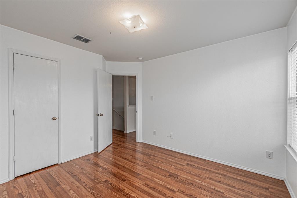 7804 Hidden Path Lane Denton, TX 76210 - Photo 29 of 40 Unfurnished bedroom with wood finished floors