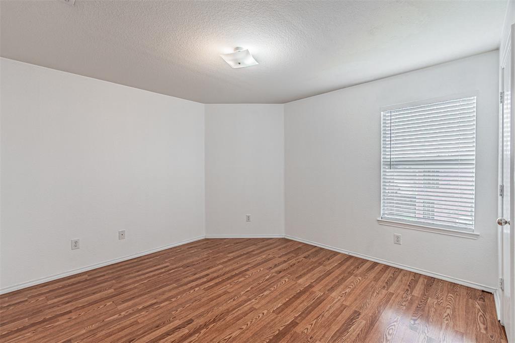 7804 Hidden Path Lane Denton, TX 76210 - Photo 30 of 40 a view of empty room with wooden floor and fan