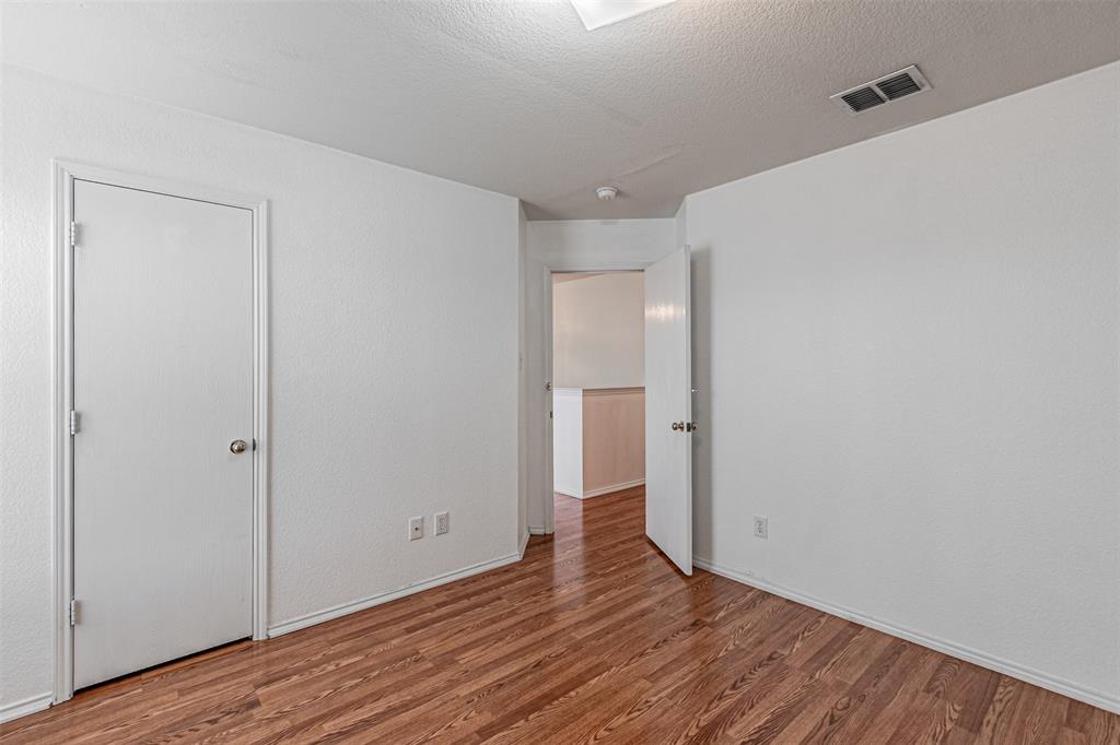 7804 Hidden Path Lane Denton, TX 76210 - Photo 31 of 40 a view of an empty room with wooden floor