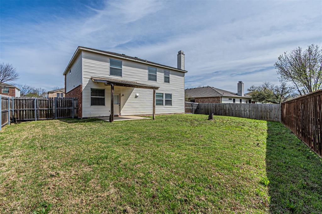 7804 Hidden Path Lane Denton, TX 76210 - Photo 38 of 40 Rear view of house with a patio, a fenced backyard, and a chimney