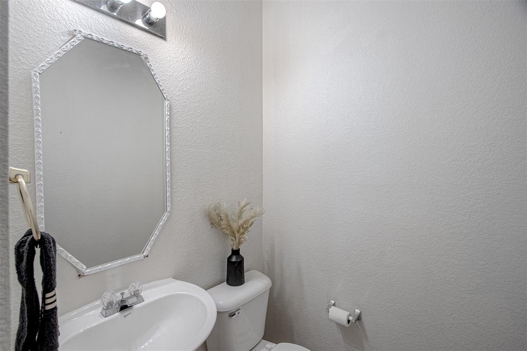 7804 Hidden Path Lane Denton, TX 76210 - Photo 5 of 40 Half bathroom with toilet and a sink