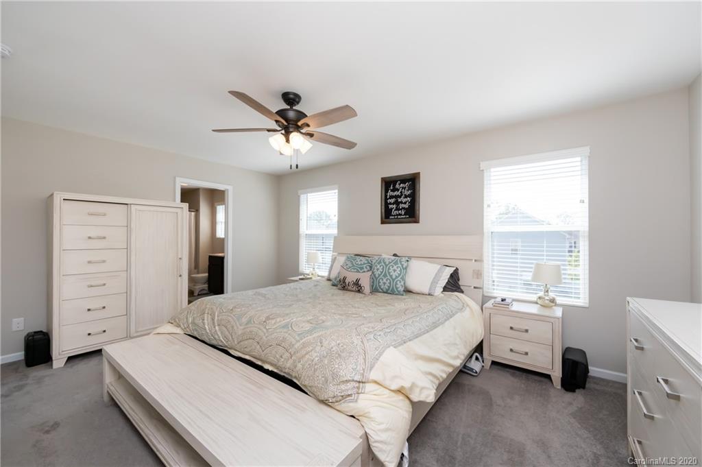 12525 Garron Road Midland, NC 28107 - Photo 22 of 41 a spacious bedroom with a bed a window and a lamp