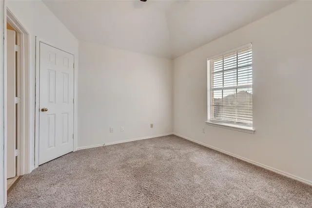 a bathroom with a tub shower and window