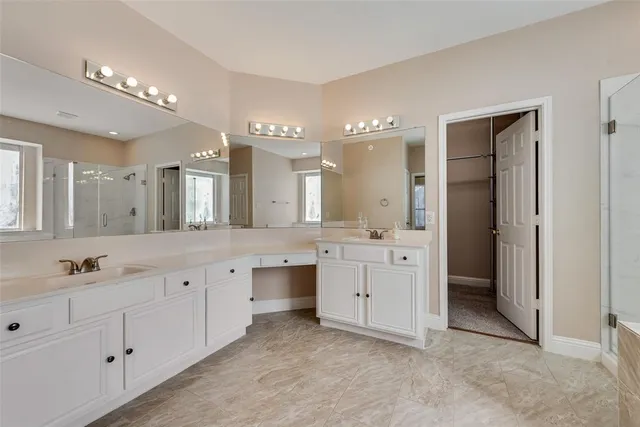 a kitchen with a sink a counter top space stainless steel appliances and cabinets
