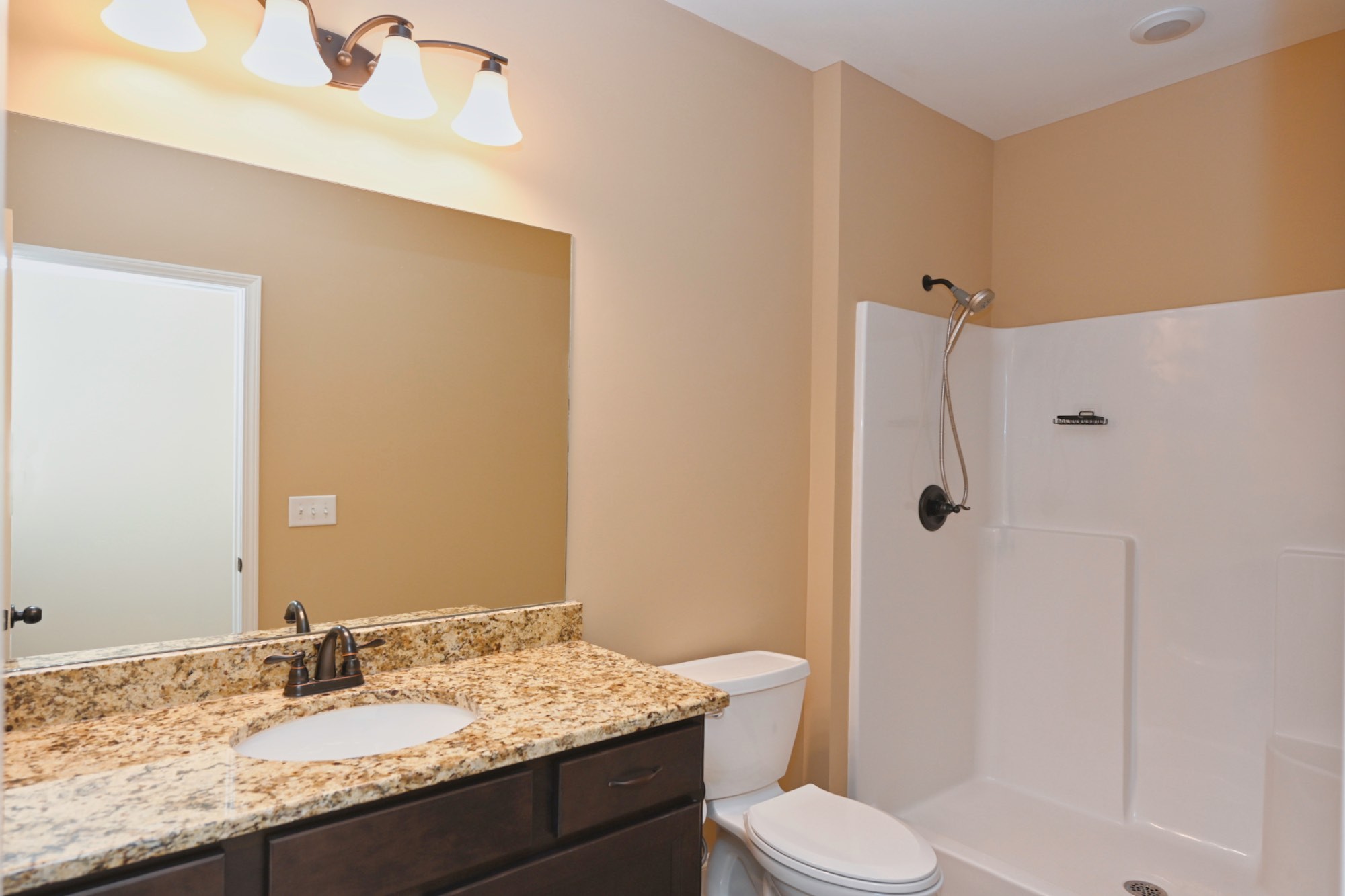 6952 Cainsville Road Lebanon, TN 37090 - Photo 31 of 48 a bathroom with a granite countertop sink toilet mirror and shower