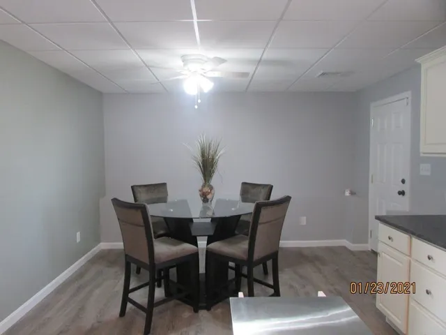 a view of a dining room with furniture and chandelier