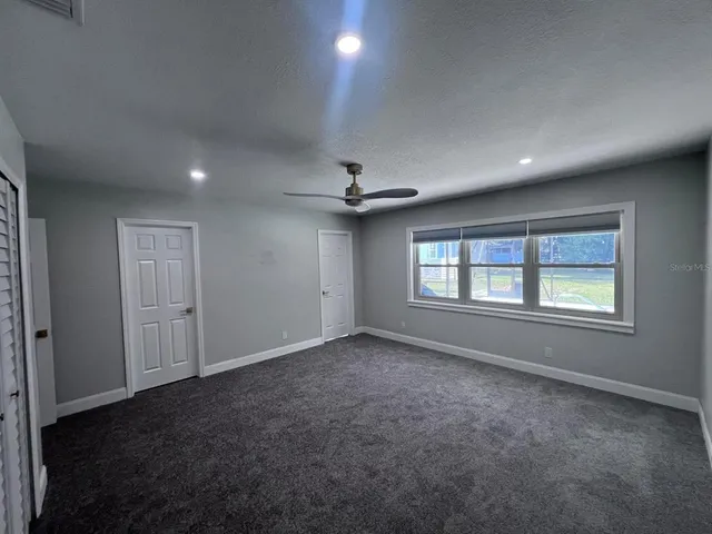 a spacious bathroom with a double vanity sink and mirror