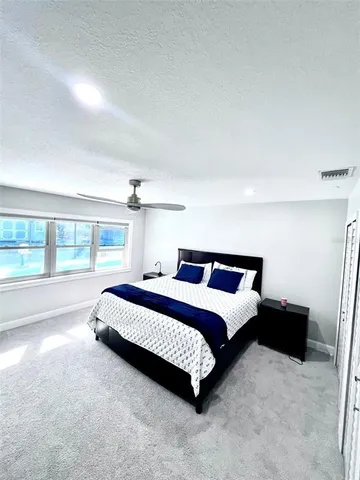 a view of an empty room with a cabinet and mirror