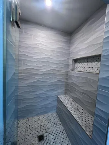 a bathroom with double vanity sinks and a mirror