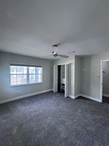 a patio with a table and chairs and potted plants