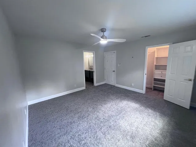 a kitchen with a wooden floor and a refrigerator
